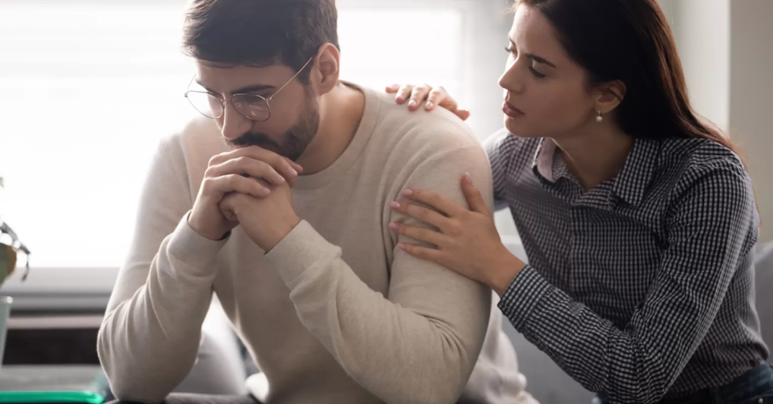 A person contemplating their feelings, struggling with the decision to confront their partner about feeling undervalued.