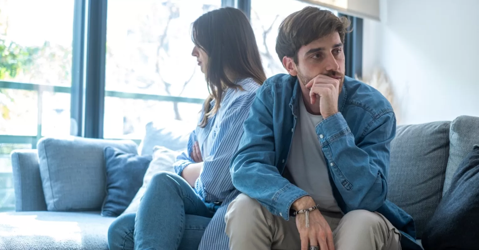 Couple sitting close yet emotionally distant, reflecting on relationship signals