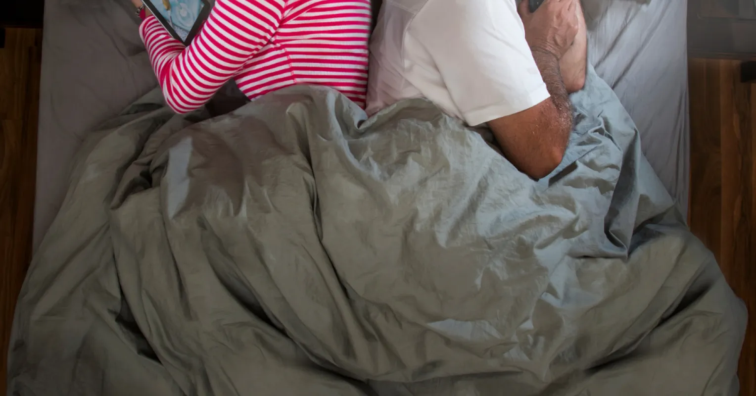 Couple sitting apart, reflecting on reasons for feeling emotionally disconnected from each other