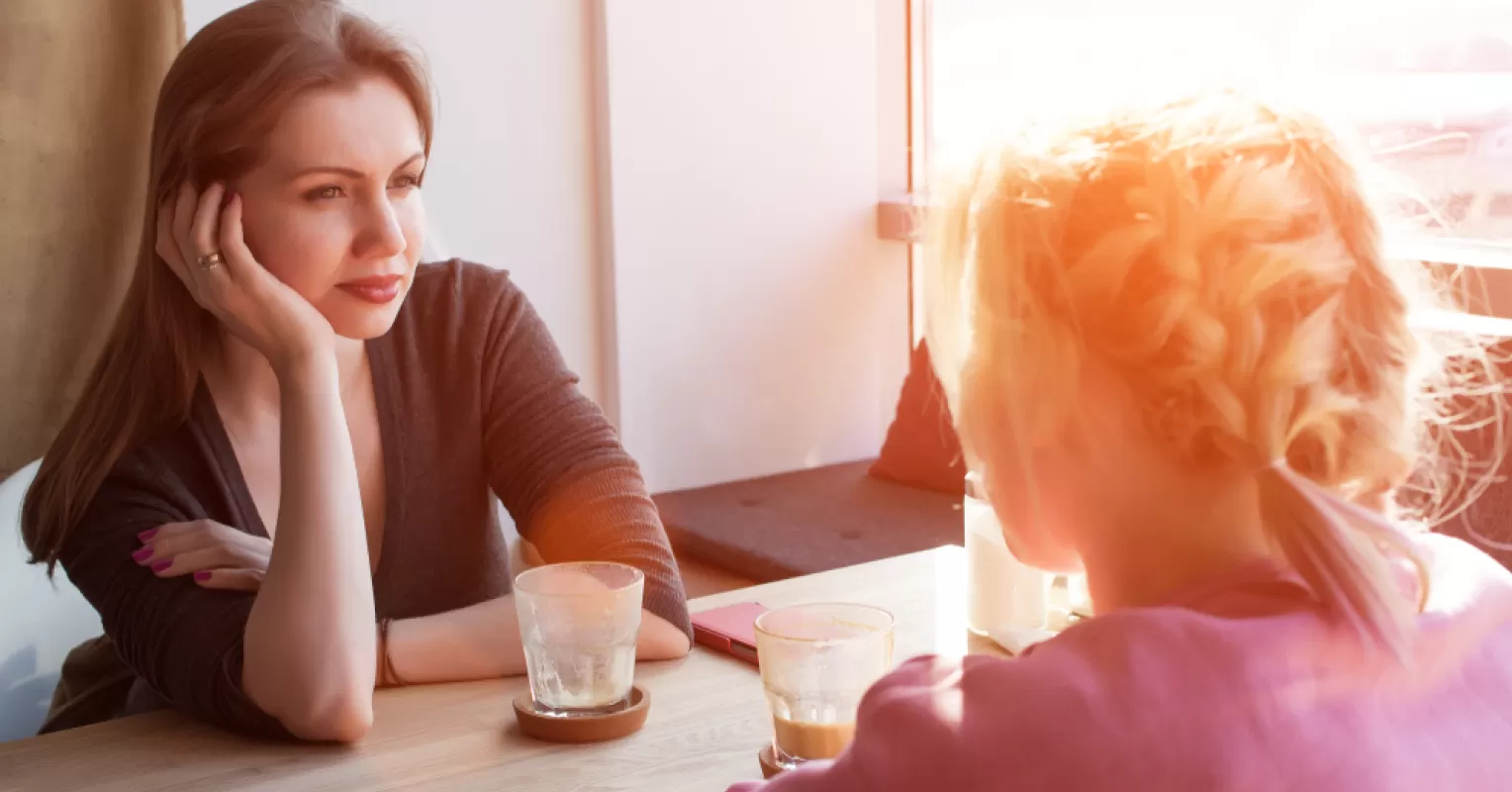 Woman feeling overlooked in a social setting, highlighting competition for male attention