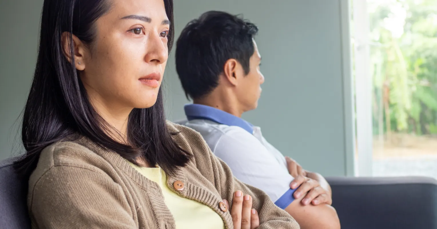 Couple sharing a quiet moment, yet one appears emotionally disengaged despite togetherness.