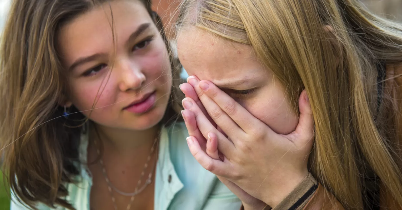 Teen feeling isolated after a breakup, reflecting on changed friendships