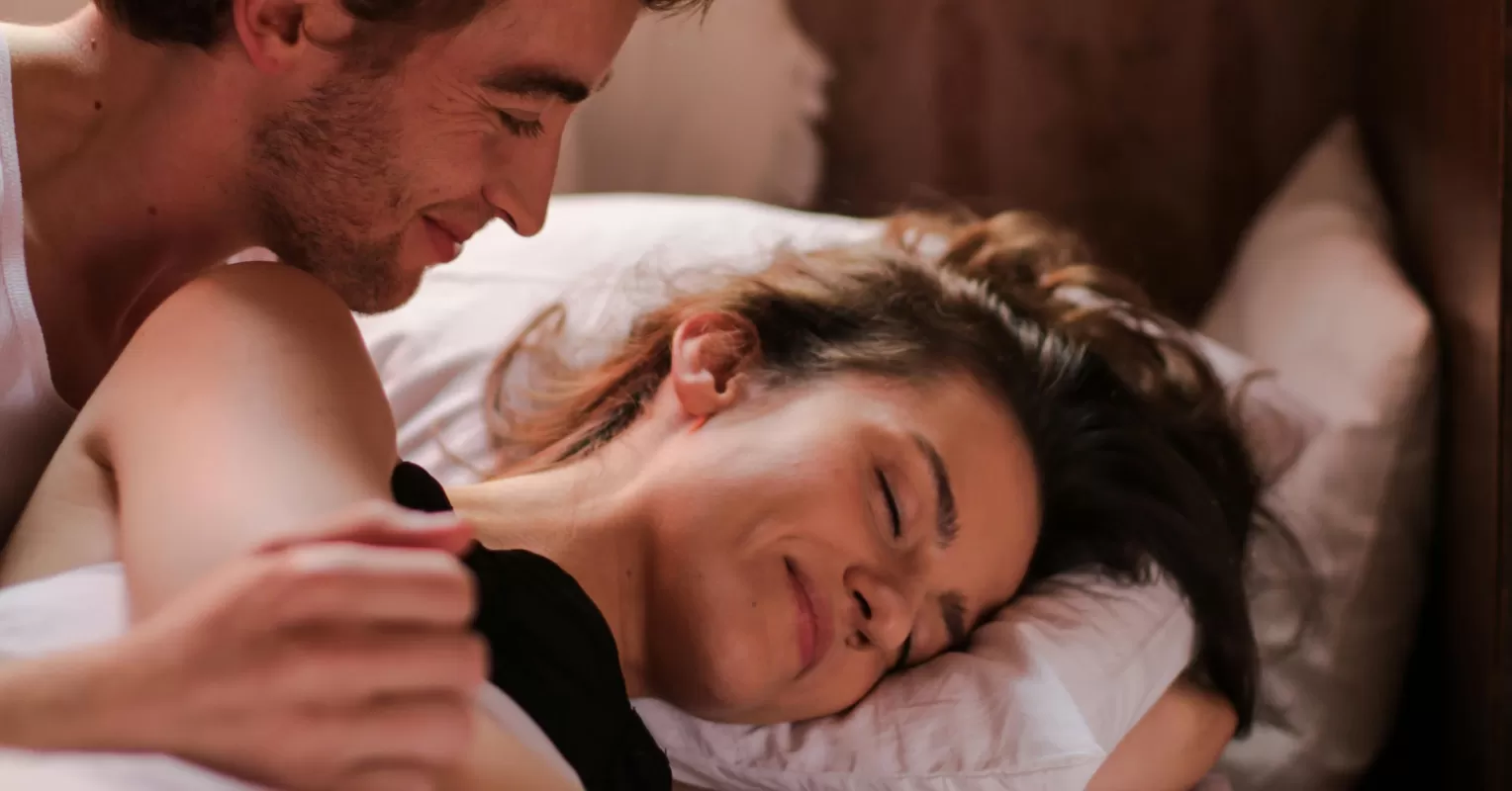 Couple appearing distant after intimacy, reflecting relationship signals and emotional disconnect