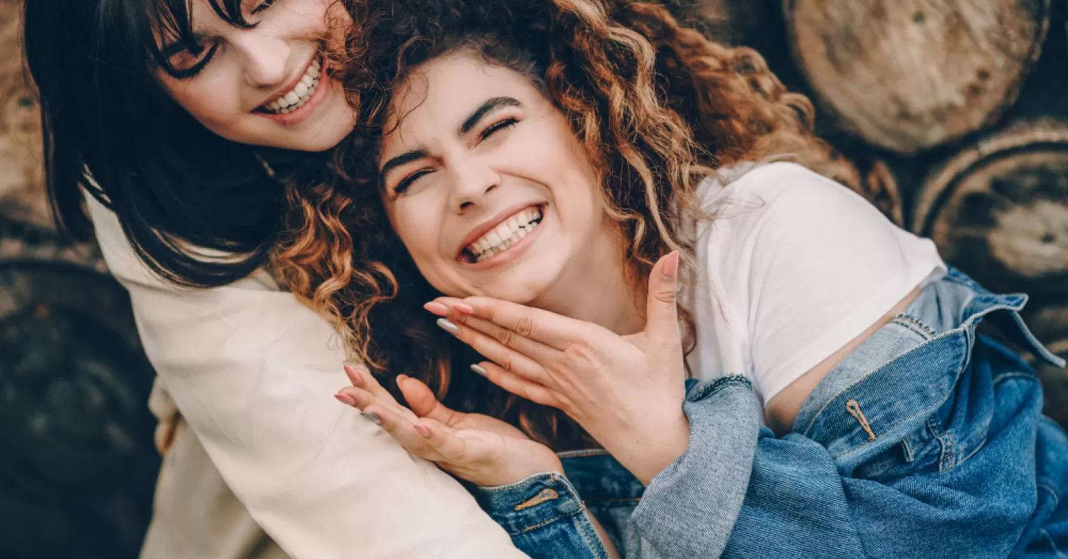 Group of friends communicating, while one person looks hurt by the best friend talk