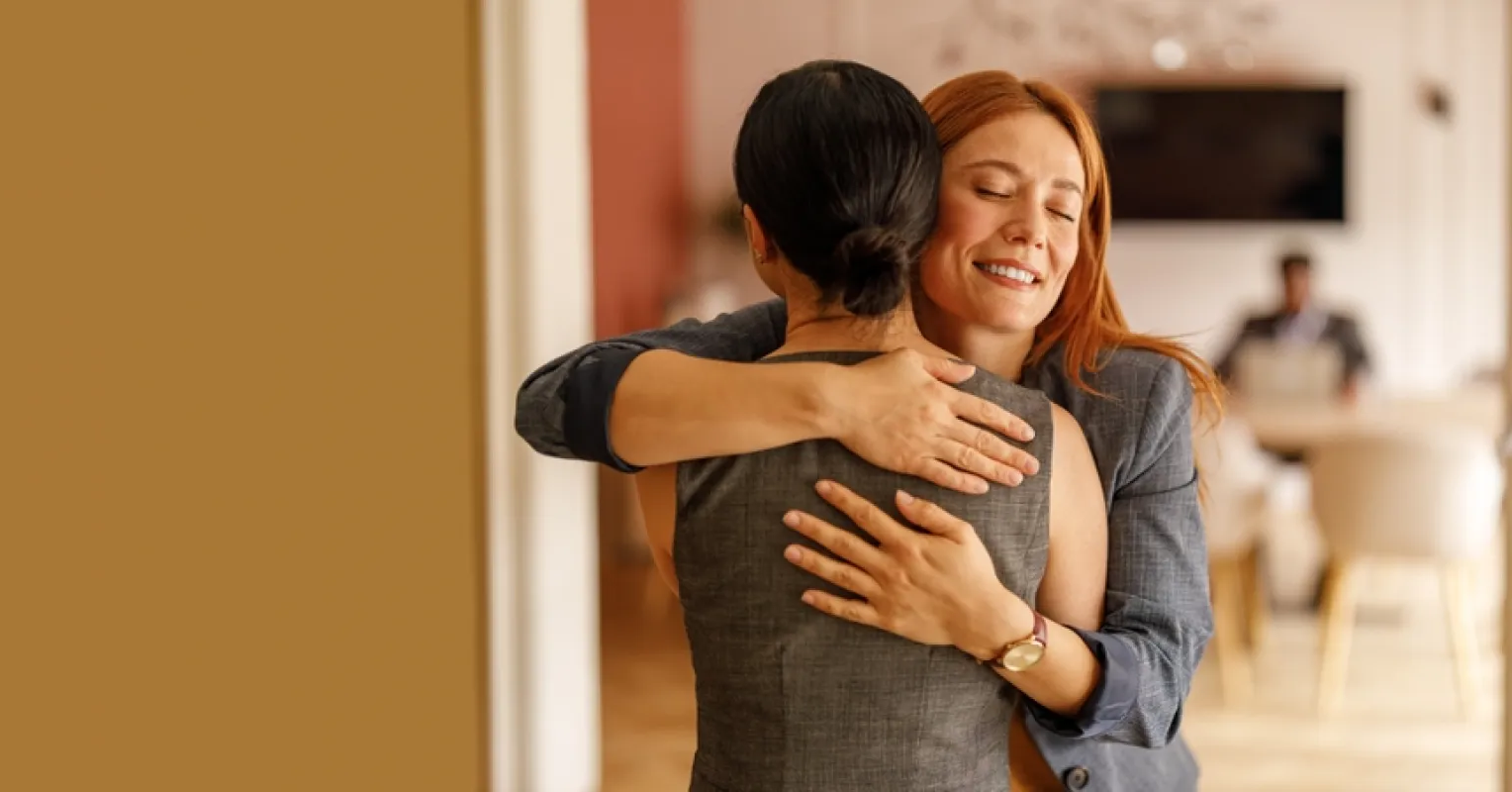 A warm embrace between two friends illustrating why hugging fosters closeness in relationships