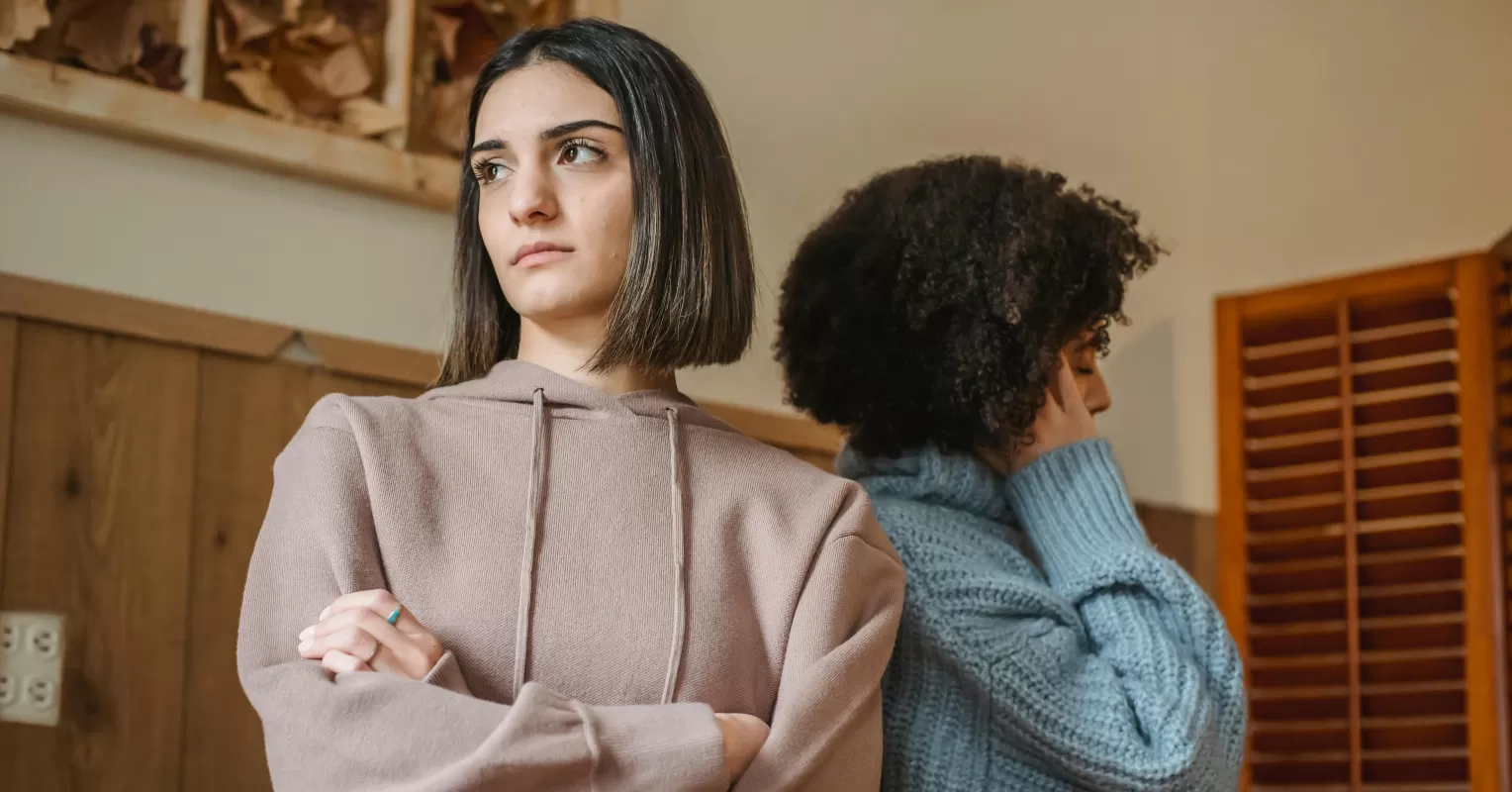 Individual feeling overlooked while family members engage, reflecting on the 'lost child' role.