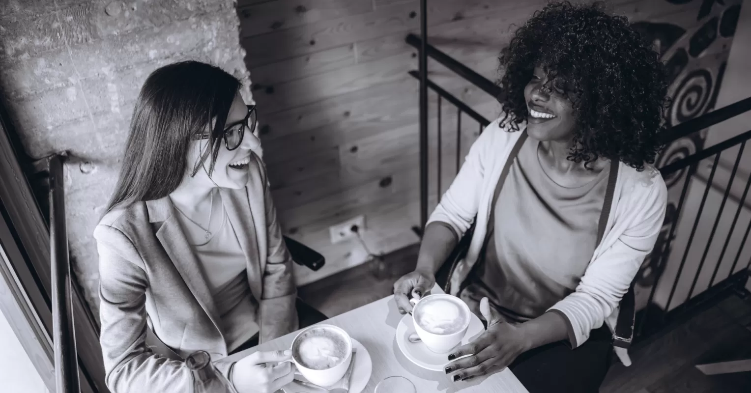 Group of friends sharing laughs while one person hesitates to join the conversation
