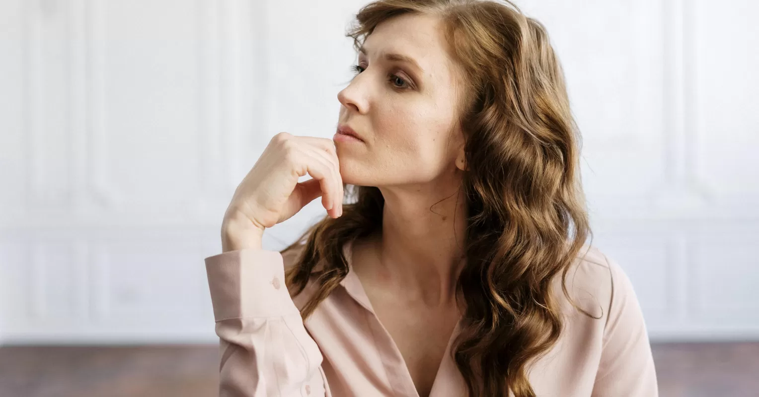 Individual pausing thoughtfully, reflecting on why they hesitate to express feelings in relationships
