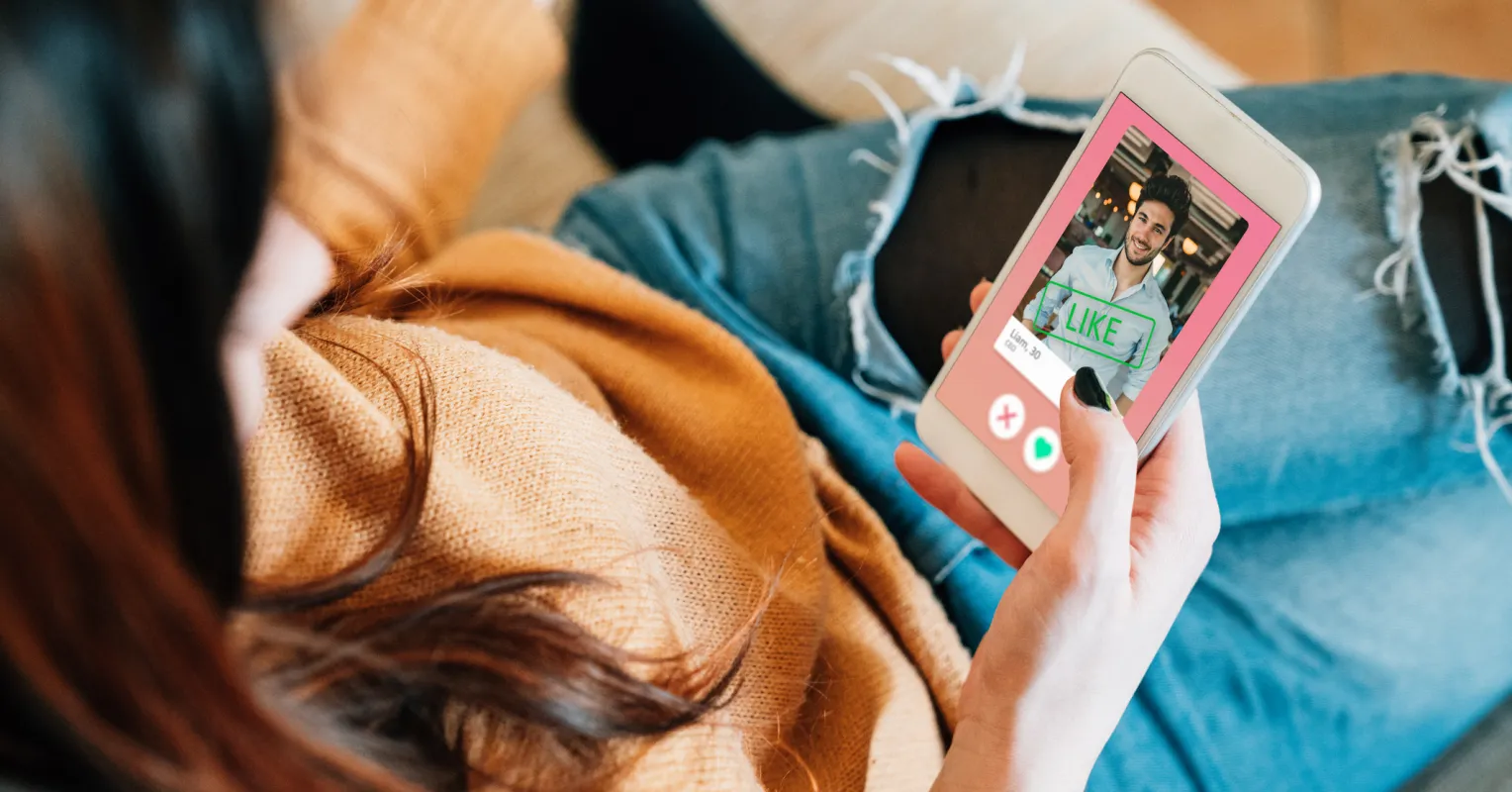 Person contemplating their self-worth while swiping through a dating app