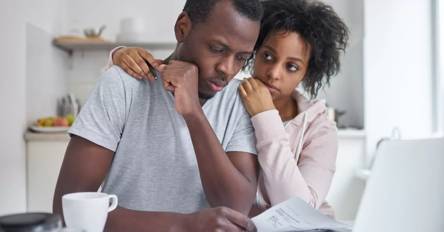 Couple sitting apart, reflecting on emotional disconnect in their long-term marriage