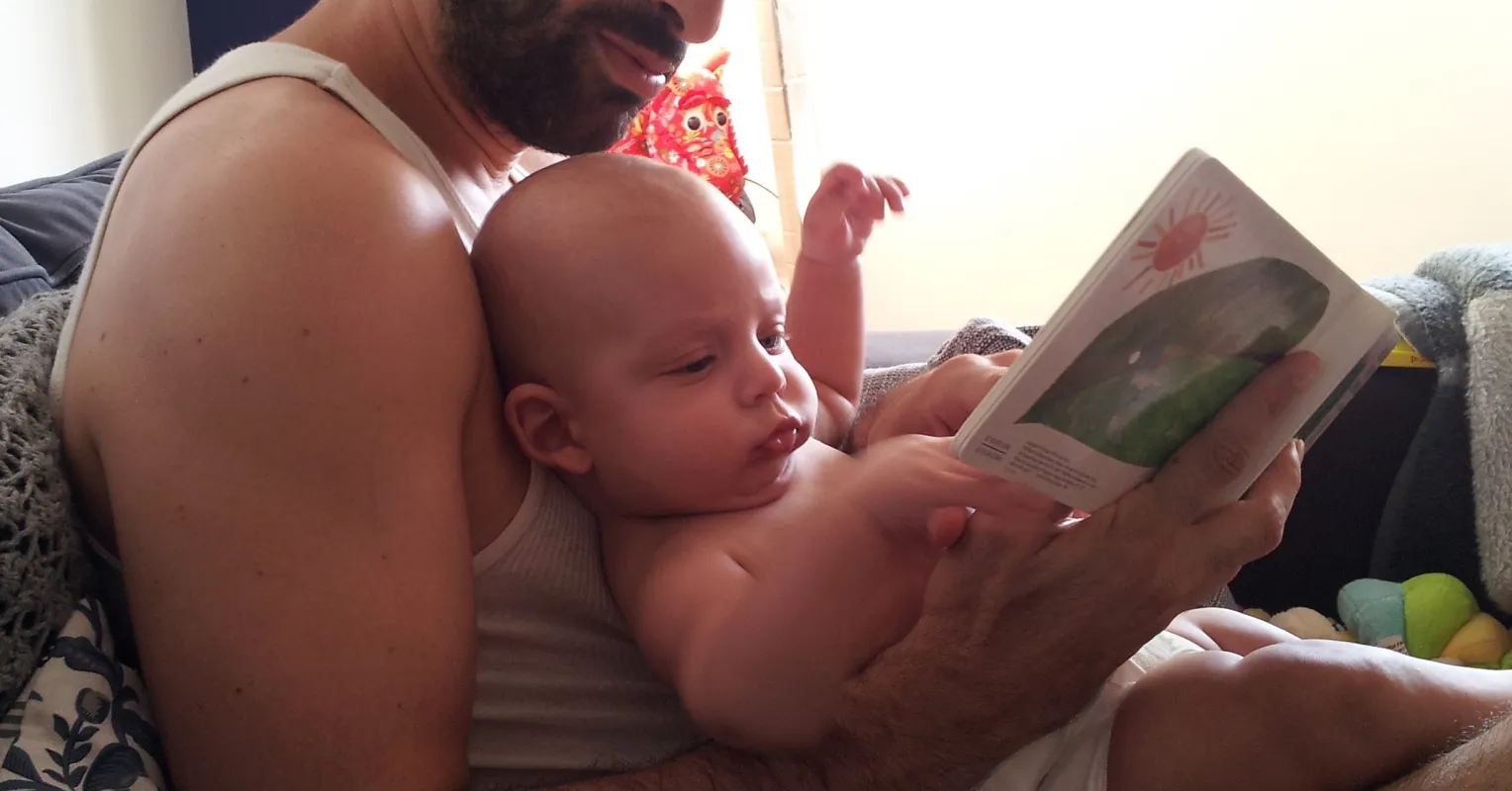 Father and son sitting together, discussing emotions and improving their connection