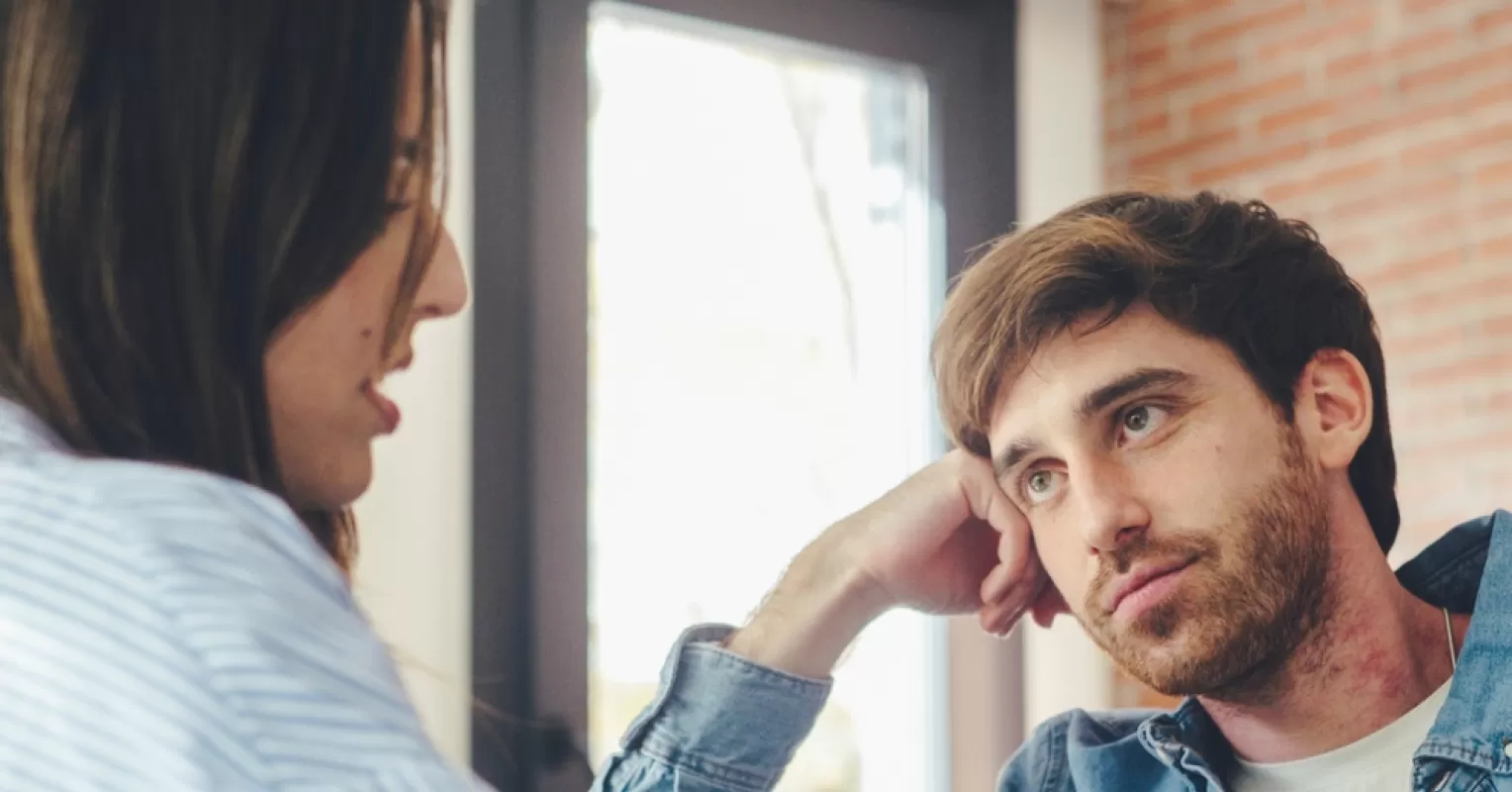 Couple sitting in silence, highlighting disengagement during important conversations