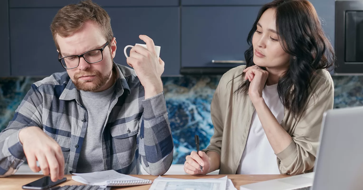 Couple engaged in a serious conversation about money, highlighting emotional triggers in relationships
