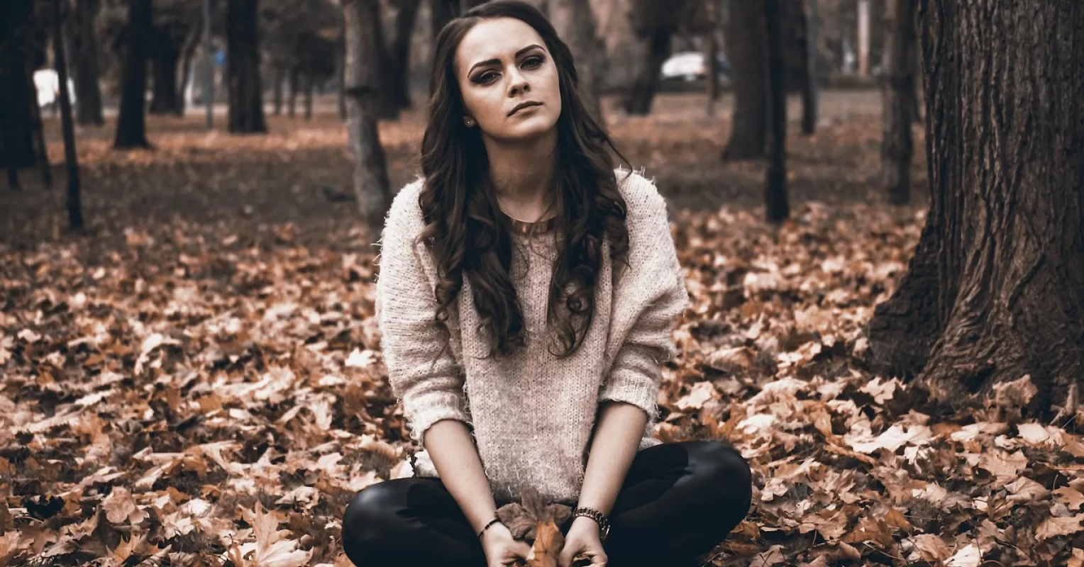 Person contemplating self-worth while reflecting on feelings of inadequacy after rejection