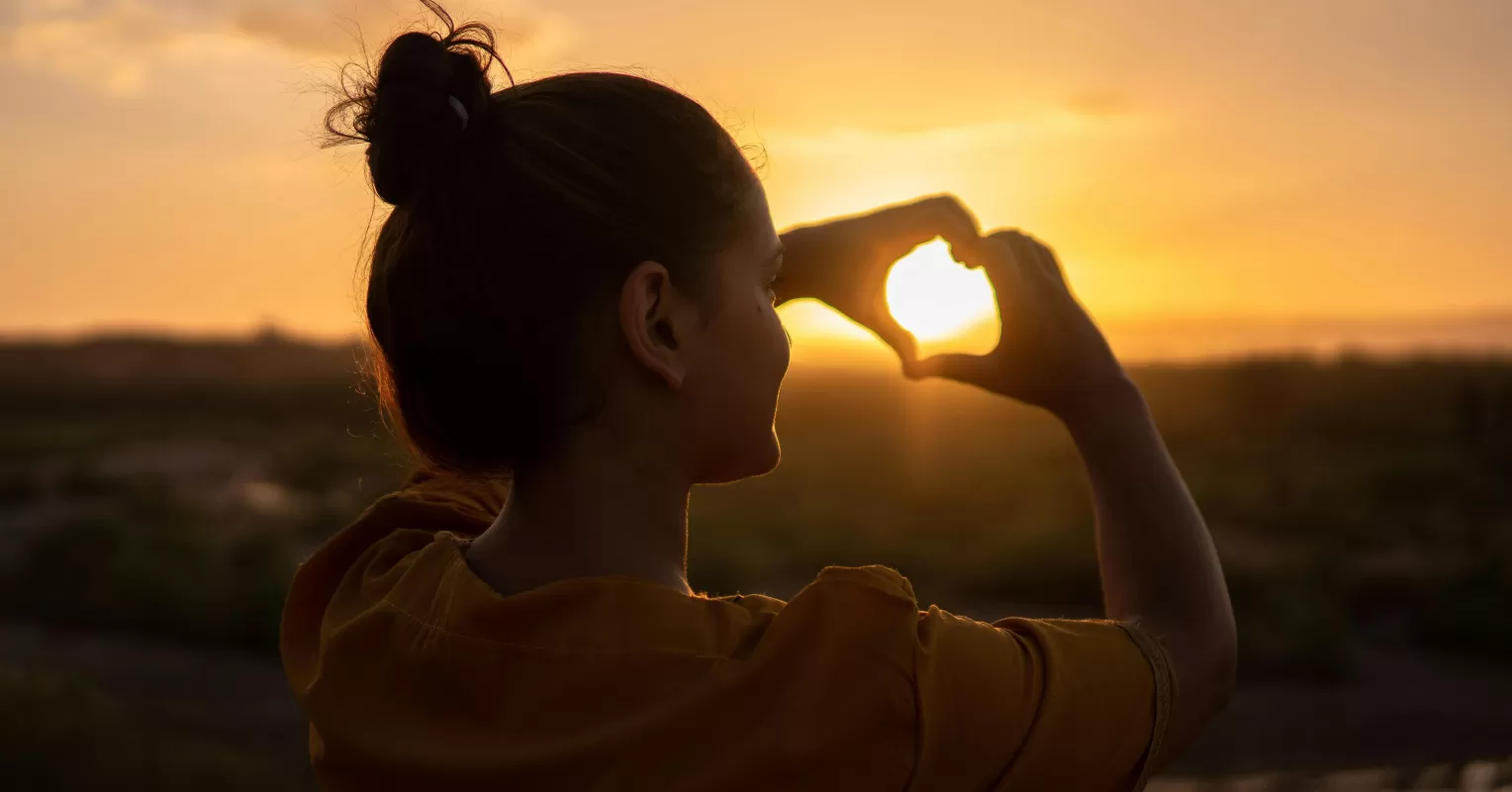 Woman walking in nature, reflecting on how to reconnect with yourself after a breakup