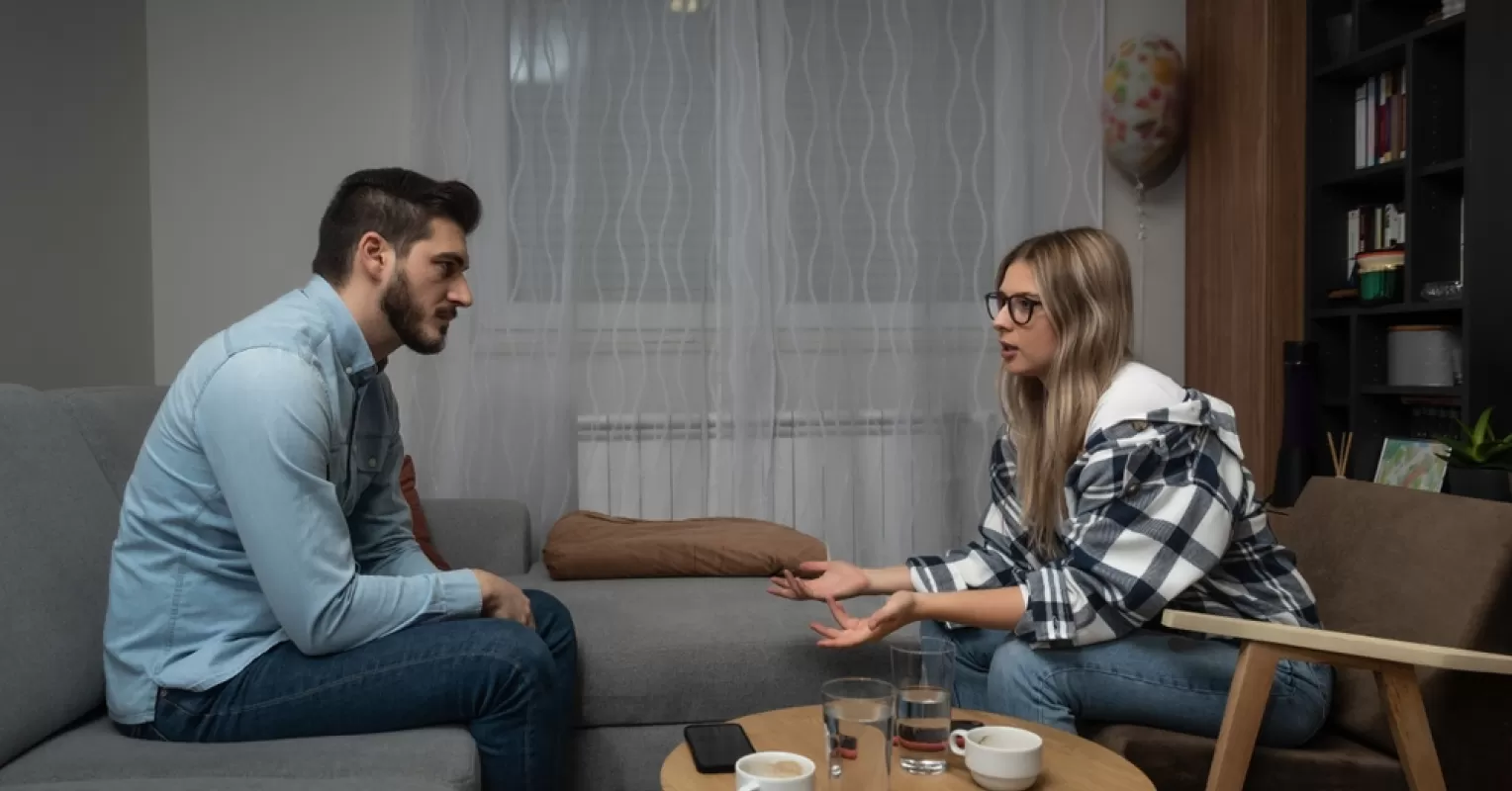 A person feeling frustrated while trying to engage a partner in conversation about unresolved issues
