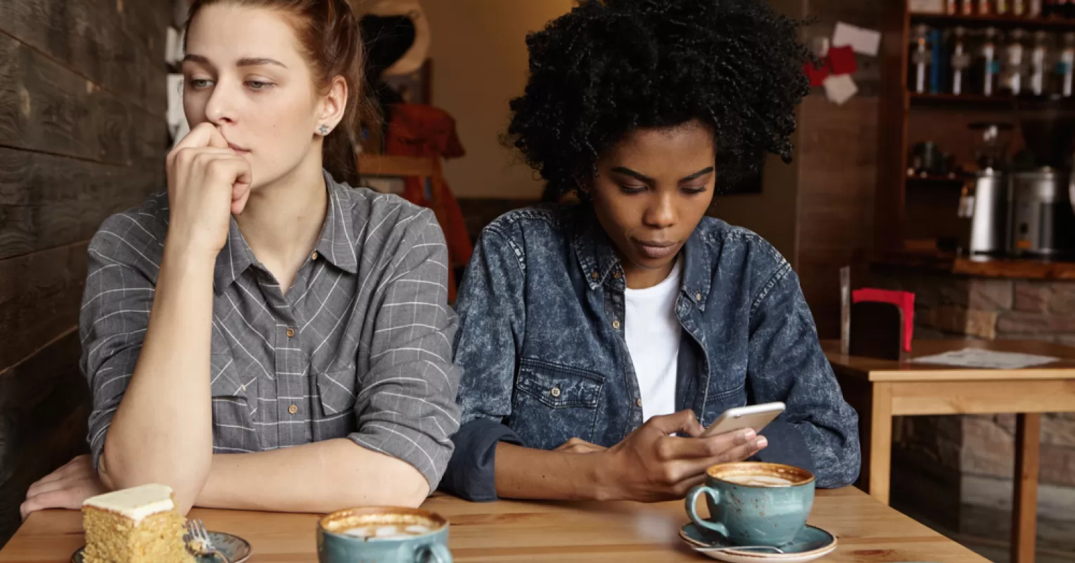 Couple sitting together, one partner showing signs of feeling overwhelmed while the other listens attentively.