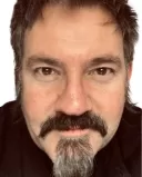Individual expressing genuine remorse while delivering a sincere apology in a conversation