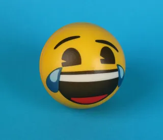 Individual contemplating the implications of laughter emojis in serious conversations