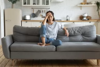 Couple sitting in silence, indicating emotional distance despite claims of happiness.