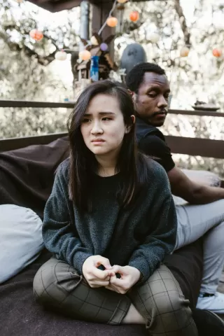 Individual experiencing anxiety during a tough conversation about emotions and communication