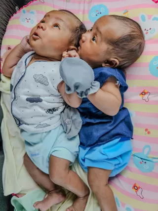Two twins engaging in a heartfelt conversation about embracing their differences