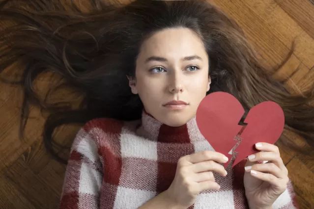 Individual practicing self-care after the emotional turmoil of a relationship ending