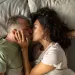 Two people sharing a laugh, indicating potential flirting and relationship signals