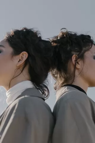 Twins sharing an intimate moment, illustrating the deep emotional patterns in their relationship