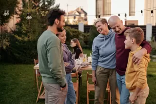 Individual calmly discussing personal limits with family during a family gathering
