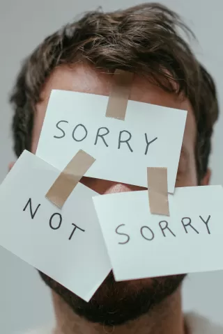 Individual expressing remorse during a heartfelt apology after a disagreement