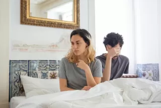 Couple discussing emotional connection in a cozy setting, exploring non-monogamous relationship signals
