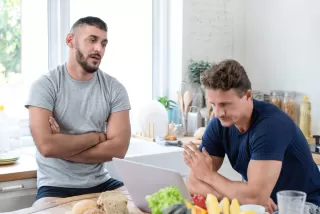 Couple engaged in a conversation, with one partner looking frustrated and unheard