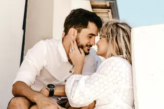 Person sitting alone, feeling overwhelmed by emotions during a new relationship.