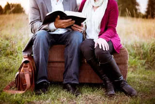 Couple at a distance, appearing disconnected while sharing a prayer, highlighting signs of emotional distance in thei...