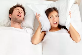 Couple sitting apart in separate rooms, reflecting on their relationship signals.