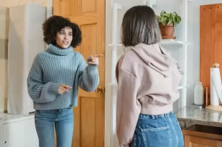 Person thoughtfully engaging in a conversation after receiving hurtful comments.