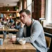 Person observing subtle cues in a conversation about hidden feelings