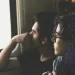 Two friends communicating online, feeling the impact of idealization in their relationship.