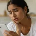 Individual feeling self-doubt while scrolling through social media profiles of peers