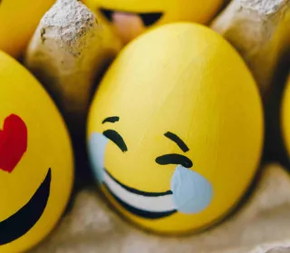 Person smiling while using laughter emojis in a serious conversation, revealing emotional dynamics
