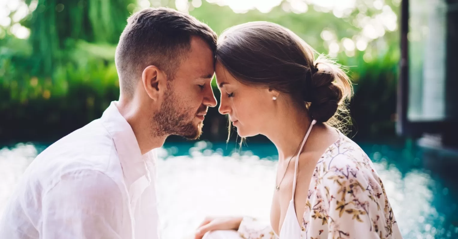 Couple sitting together, yet showing signs of emotional distance in a faith-based relationship