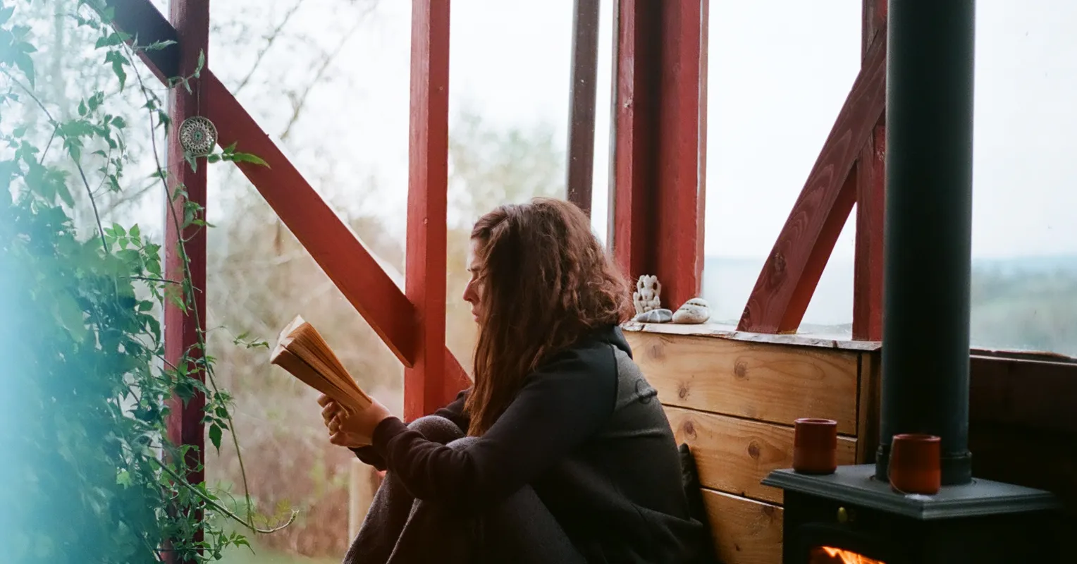 Mother reflecting on her needs while caring for her children in a busy home environment