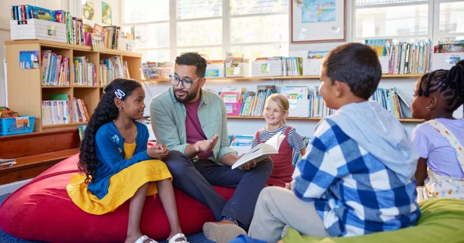 Child sitting alone in class, hinting at feelings of disconnection in school.