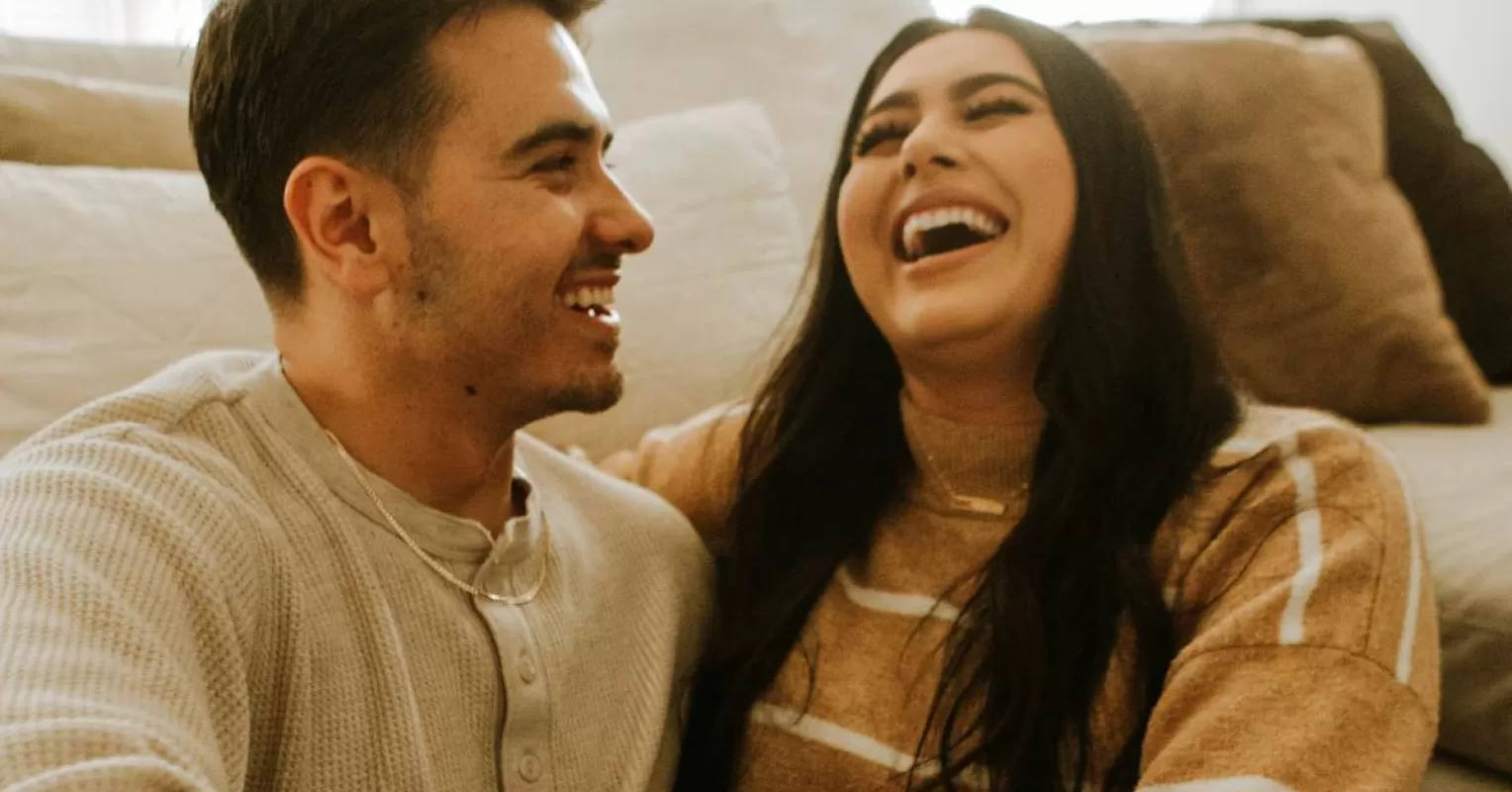 Couple sharing laughs together, highlighting humor's role in a relationship
