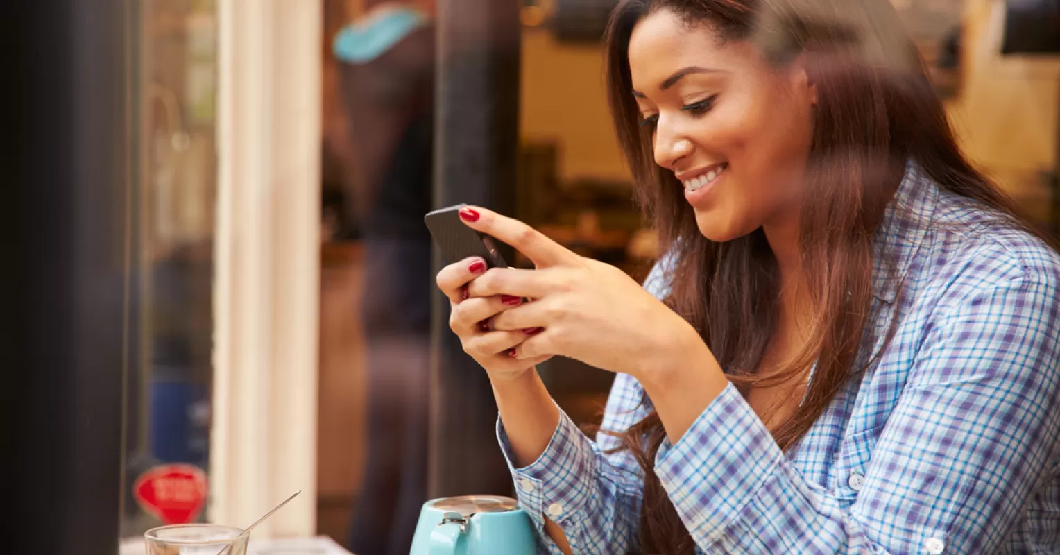 Person thoughtfully analyzing a text message from their date, reflecting on relationship signals