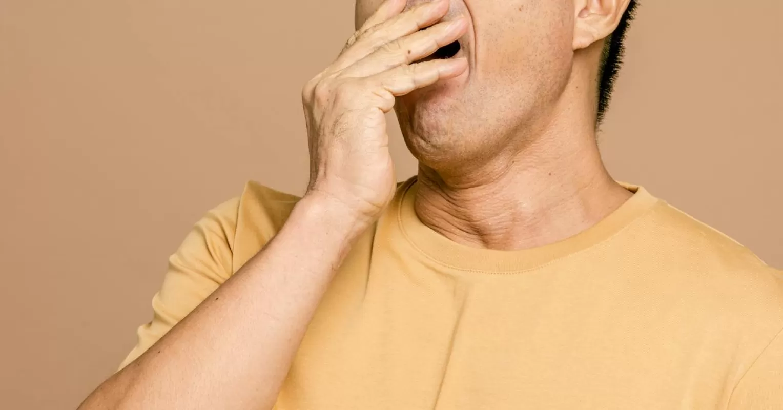 Person yawning while their partner speaks, indicating possible relationship signals.