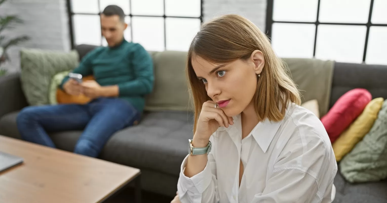 Individual contemplating the complexity of distant behavior in a caring relationship