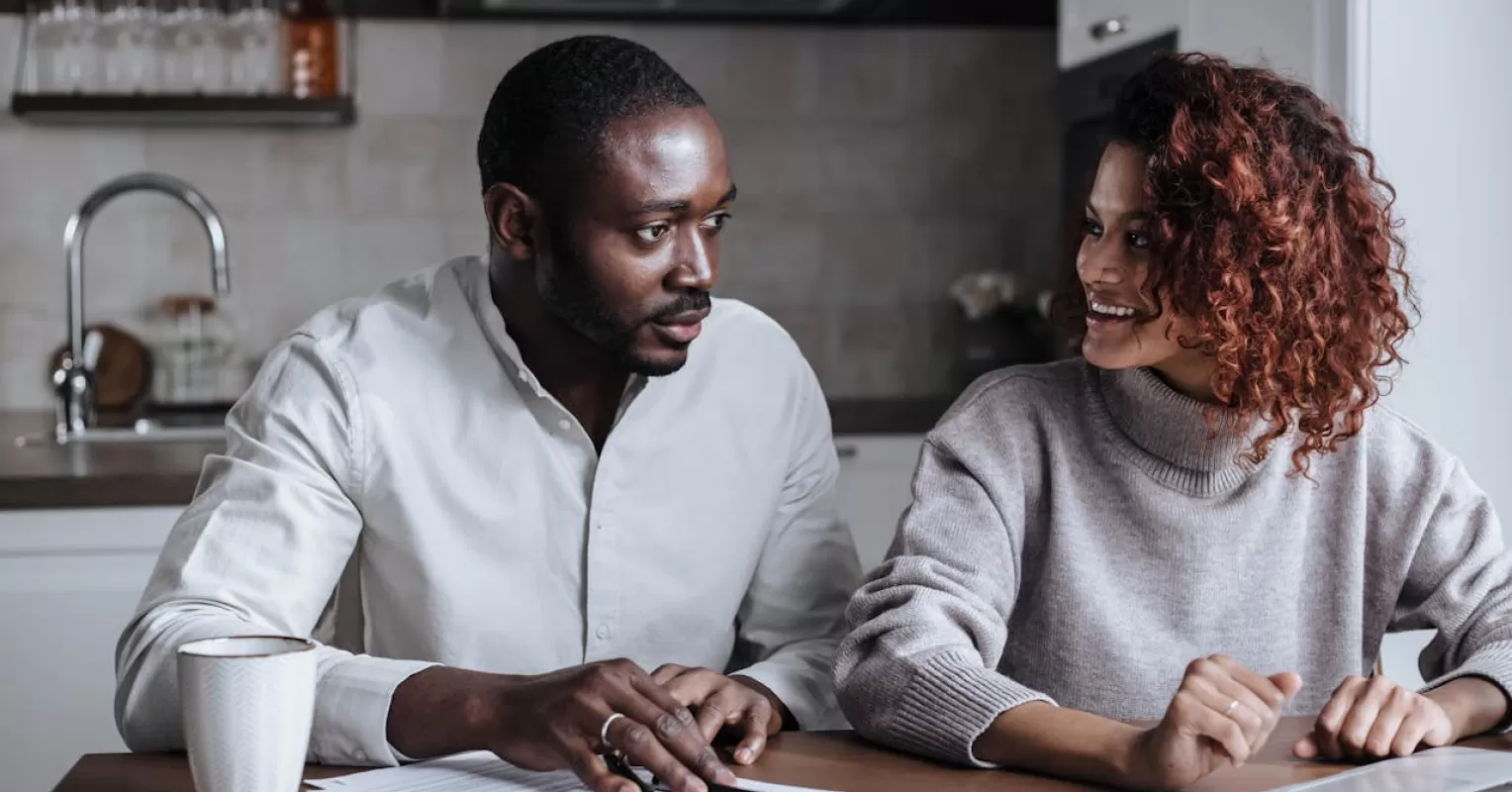 Couple experiencing tension during a conversation, highlighting avoidance of tough discussions.