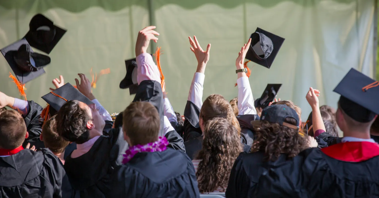 Recent graduates expressing mixed emotions at a farewell gathering, reflecting on their college experience